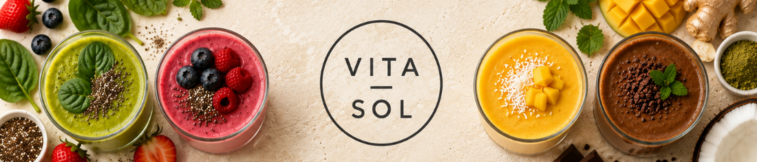 Four colourful wholefood smoothies surrounded by fresh fruit and natural ingredients with the Vita-Sol logo.